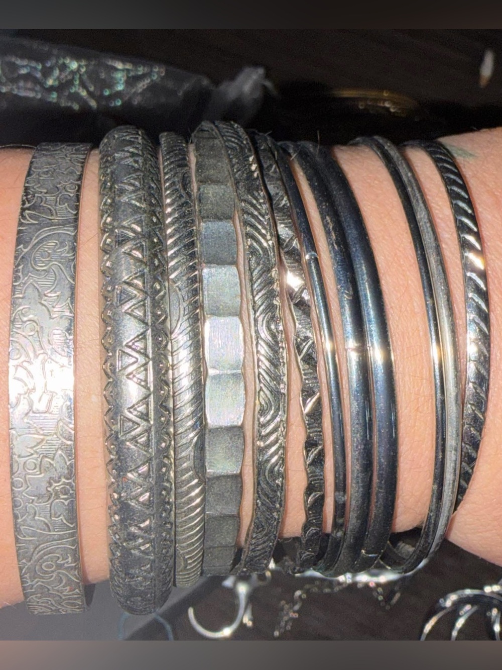 Set of 12 silver-colored bangle bracelets.